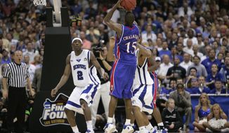 FILE - In this Monday, April 7, 2008, file photo, Kansas&#39; Mario Chalmers shoots a three pointer to take the game in to overtime against Memphis during the championship game at the NCAA college basketball Final Four in San Antonio. Kansas defeated Memphis 75-68 in overtime. (AP Photo/Mark Humphrey, File)
