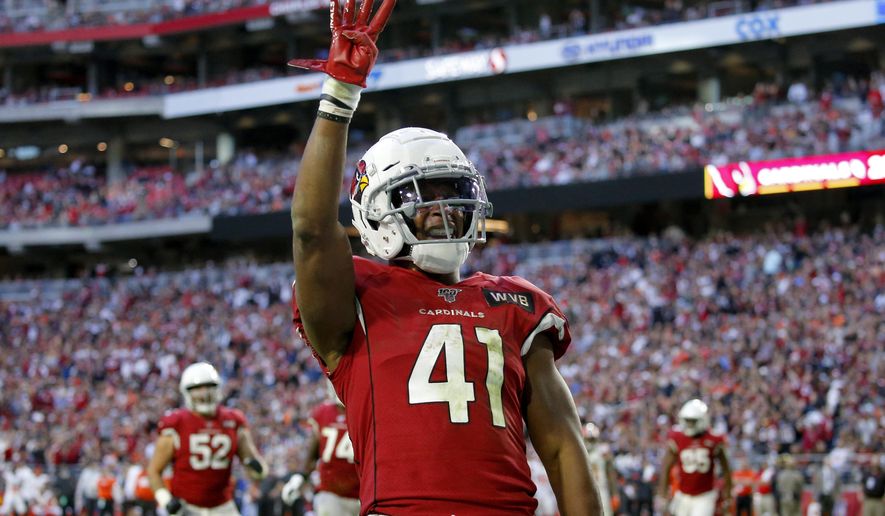 FILE - In this Dec. 15, 2019, file photo, Arizona Cardinals running back Kenyan Drake (41) motions after his fourth touchdown of the game during the second half of an NFL football game against the Cleveland Browns in Glendale, Ariz. Drake's agency said Saturday, March 21, 2020, that he will sign his one-year, $8.5 million tender to stay with the Cardinals. The Cardinals placed the transition tag on Drake earlier this week. (AP Photo/Ross D. Franklin, File)