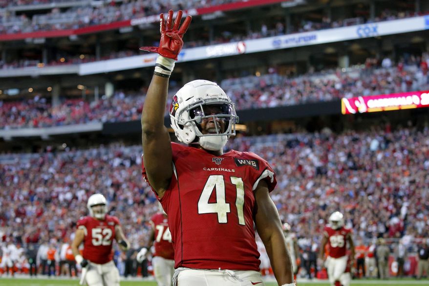 FILE - In this Dec. 15, 2019, file photo, Arizona Cardinals running back Kenyan Drake (41) motions after his fourth touchdown of the game during the second half of an NFL football game against the Cleveland Browns in Glendale, Ariz. Drake's agency said Saturday, March 21, 2020, that he will sign his one-year, $8.5 million tender to stay with the Cardinals. The Cardinals placed the transition tag on Drake earlier this week. (AP Photo/Ross D. Franklin, File)