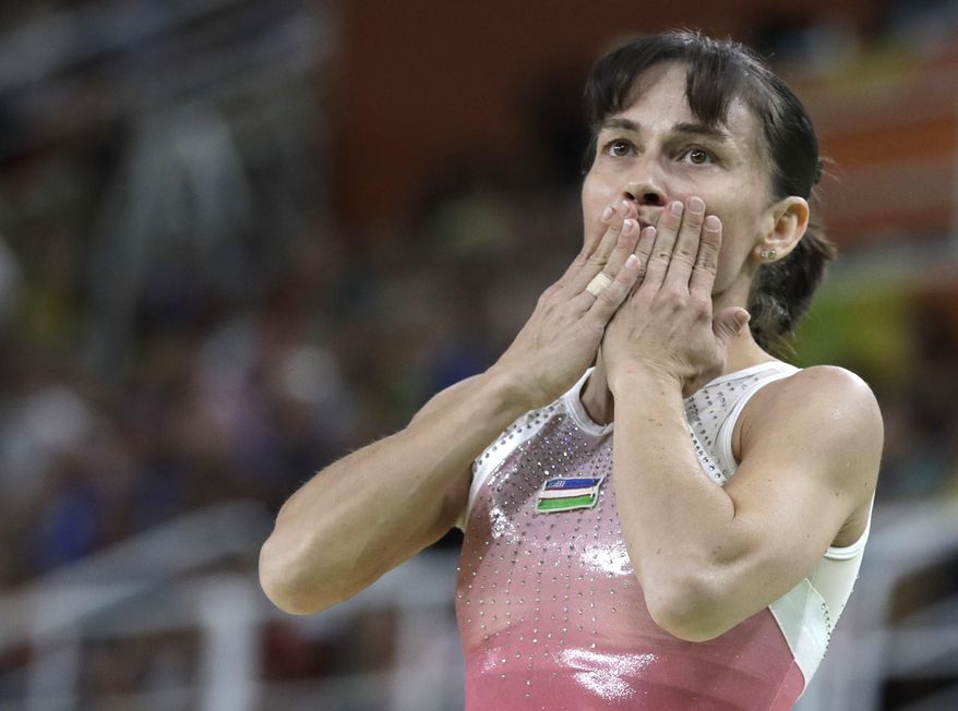 FILE - In this Sunday, Aug. 7, 2016 file photo, Uzbekistan's Oksana Chusovitina acknowledges the audience after her routine on the balance beam during the artistic gymnastics women's qualification at the 2016 Summer Olympics in Rio de Janeiro, Brazil. Chusovitina had considered retirement before but chose to carry on before qualifying for her eighth Olympics — breaking her own record in the sport. This time around, the 1992 gold medalist said Tokyo will be her last Olympics. “It's already good that they have postponed. Everything will calm down and everything will be fine, and I think then the Olympics will go ahead as normal,” said the 44-year-old Chusovitina, who is training in restricted. (AP Photo/Rebecca Blackwell, file)