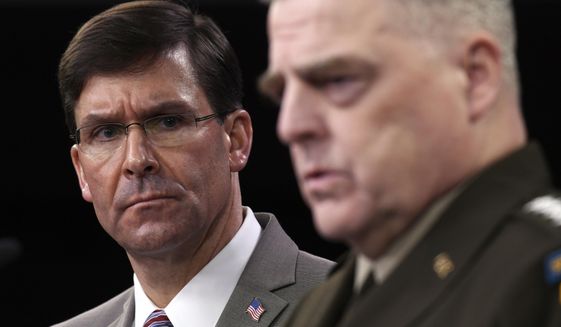 Defense Secretary Mark Esper, left, listens as Chairman of the Joint Chiefs of Staff Army Gen. Mark Milley, right, speaks during a briefing at the Pentagon in Washington, Monday, March 2, 2020. (AP Photo/Susan Walsh)