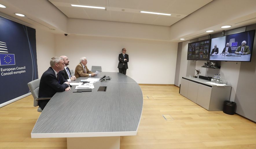 FILE - In this Tuesday, March 10, 2020 file photo, European Council President Charles Michel, second left, participates in a video conference call with EU leaders at the European Council building in Brussels. European Union leaders are convening by video conference Thursday, March 26, 2020, for their third summit in three weeks, as they battle to contain the spread of the coronavirus. The new coronavirus causes mild or moderate symptoms for most people, but for some, especially older adults and people with existing health problems, it can cause more severe illness or death. (Stephanie Lecocq, Pool Photo via AP, File)