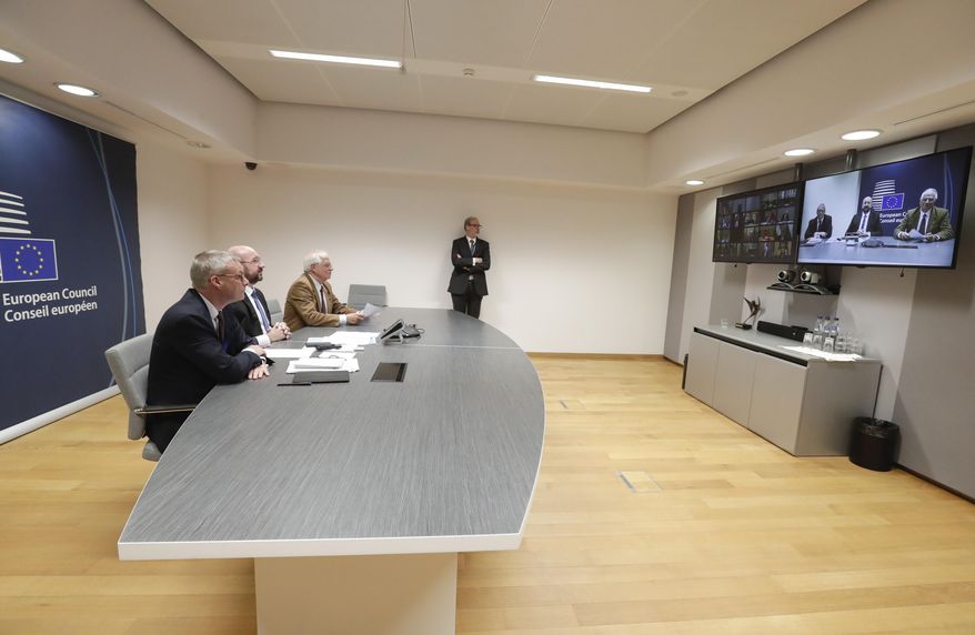 FILE - In this Tuesday, March 10, 2020 file photo, European Council President Charles Michel, second left, participates in a video conference call with EU leaders at the European Council building in Brussels. European Union leaders are convening by video conference Thursday, March 26, 2020, for their third summit in three weeks, as they battle to contain the spread of the coronavirus. The new coronavirus causes mild or moderate symptoms for most people, but for some, especially older adults and people with existing health problems, it can cause more severe illness or death. (Stephanie Lecocq, Pool Photo via AP, File)