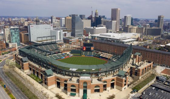 In this aerial photo, Oriole Park at Camden Yards is closed on what would&#x27;ve been Opening Day, Thursday March 26, 2020, in Baltimore, Md. The Orioles were slated to host the New York Yankees at the park, but the season has been delayed due to the coronavirus outbreak. (AP Photo/Steve Helber) **FILE**