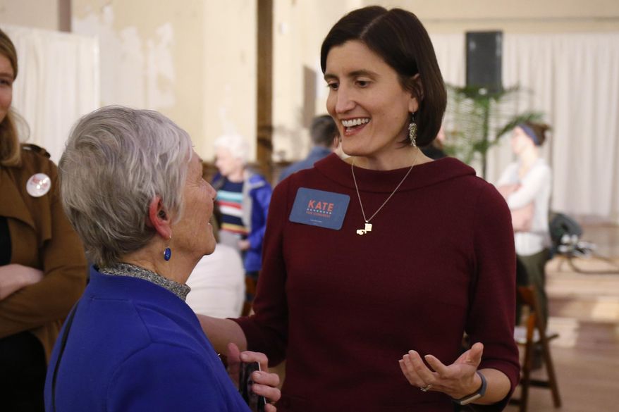 FILE—In this Feb. 18, 2020, file photo,Kate Schroder, Democratic candidate for Ohio's first congressional district, right, greets a woman following a question and answer session held by the Bold New Democracy Work Group, in Cincinnati. In Ohio, candidates such as Schroder and Nikki Foster nearly emptied their campaign coffers in the closing days before March 17, and now are focusing on social media and phone banks to keep up their campaigns while awaiting clarity on when the primary will end amid the coronavirus stay-home orders. (AP Photo/Gary Landers, File)