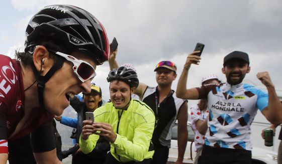 FILE - In this file photo taken on July 25, 2019 spectators cheer Britain&#39;s Geraint Thomas climbing the Galibier pass during the eighteenth stage of the Tour de France cycling race between Embrun and Valloire. Swarms of fans clog the city streets, winding roads and soaring mountain passes of the Tour de France during cycling&#39;s three-week showpiece. But unlike almost every other major sporting event it has yet to be called off because of the coronavirus and the start date remains June 27. The new coronavirus causes mild or moderate symptoms for most people, but for some, especially older adults and people with existing health problems, it can cause more severe illness or death. (AP Photo/ Christophe Ena, File)