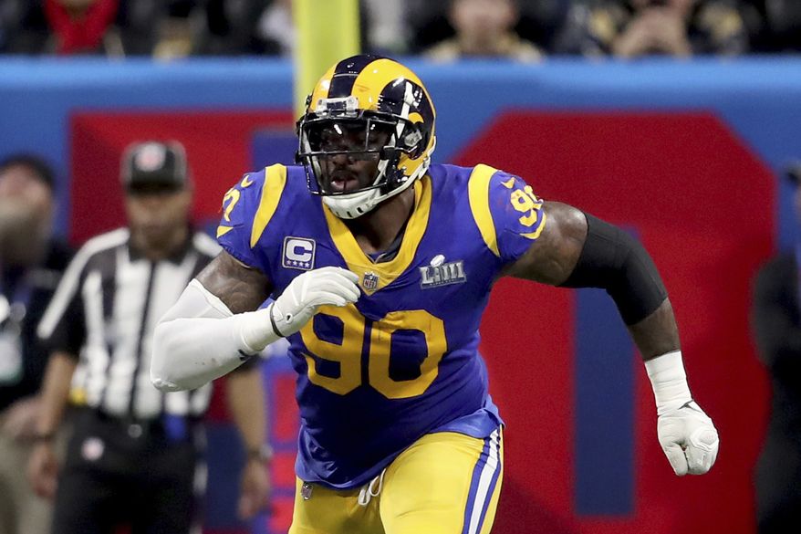 In this Feb. 3, 2019, photo, Los Angeles Rams Michael Brockers is shown in action against the New England Patriots during NFL Super Bowl 53 in Atlanta. Brockers is re-signing with the Los Angeles Rams after his free agent deal with the Ravens fell through, apparently because Baltimore's team doctors couldn't examine him properly due to the coronavirus pandemic. Brockers' representatives at Team Sports Agency confirmed the surprising reversal Friday, March 27, 2020. (AP Photo/Gregory Payan) **FILE**