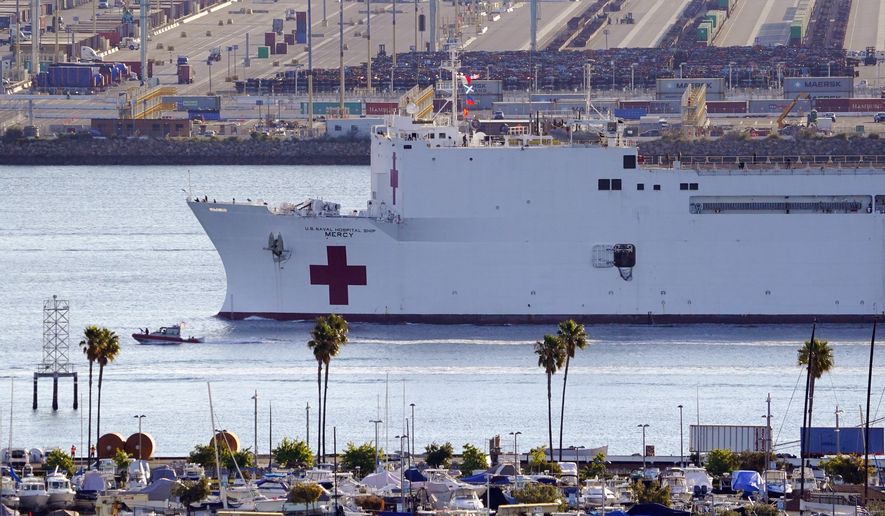 The US Naval Ship Mercy enters the Port of Los Angeles, Friday, March 27, 2020, in Los Angeles. The 1,000-bed Navy hospital ship is expected to help take the load off Los Angeles area hospitals as they treat coronavirus patients. The new coronavirus causes mild or moderate symptoms for most people, but for some, especially older adults and people with existing health problems, it can cause more severe illness or death. (AP Photo/Mark J. Terrill)