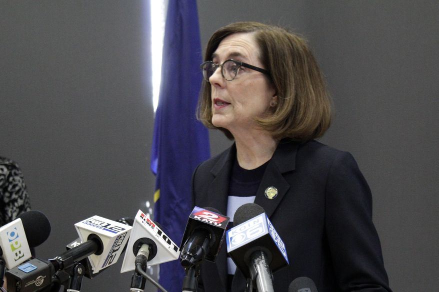 FILE - In this Monday, March 16, 2020 file photo, Gov. Kate Brown speaks at a news conference to announce a four-week ban on eat-in dining at bars and restaurants throughout the state in Portland, Ore., to slow the spread of the new coronavirus. I am gravely concerned about our ability to deliver basic services over the next six months to a year given the drop in revenues, and thats why I am encouraging the Legislature to be extremely fiscally prudent, Brown, a Democrat, said about building the budget for the coming fiscal year. (AP Photo/Gillian Flaccus)