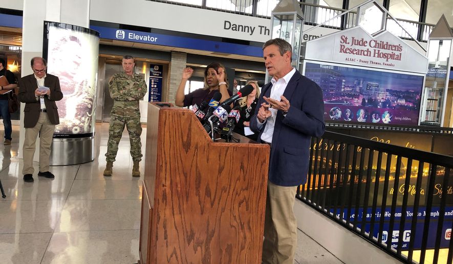 Tennessee Gov. Bill Lee (right, at podium) speaks to reporters at Memphis International Airport about the state&#x27;s response to the new coronavirus on Friday, March 27, 2020, in Memphis, Tenn. (AP Photo/Adrian Sainz).