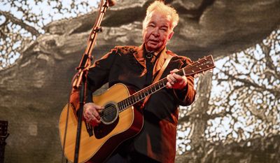 This June 15, 2019, file photo shows John Prine performing at the Bonnaroo Music and Arts Festival in Manchester, Tenn. (Photo by Amy Harris/Invision/AP, File)