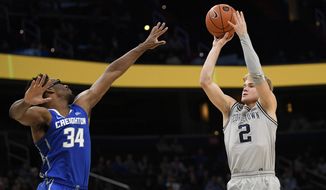 Georgetown guard Mac McClung (2) shoots as he is defended by Creighton guard Denzel Mahoney (34) during the second half of an NCAA college basketball game, Wednesday, Jan. 15, 2020, in Washington. Georgetown won 83-80. (AP Photo/Nick Wass)