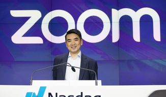 In this April 18, 2019, file photo, Zoom CEO Eric Yuan attends the opening bell at Nasdaq as his company holds its IPO in New York. Millions of people are now working from home as part of the intensifying fight against the coronavirus outbreak. Besides relying on Zoom, the video conference service, more frequently as part of their jobs, more people are also tapping it to hold virtual happy hours with friends and family banned from gathering in public places. (AP Photo/Mark Lennihan, File)