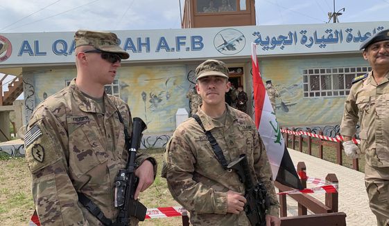 U.S. soldiers stand guard during the handover ceremony of Qayyarah Airfield, Iraqi Security Forces, in the south of Mosul, Iraq on early Friday, March 27, 2020. (AP Photo/Ali Abdul Hassan) **FILE**