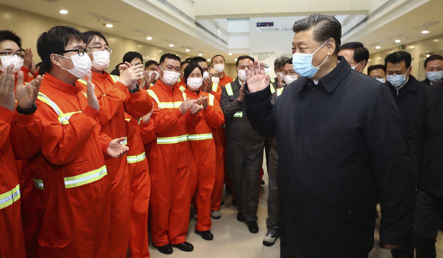 In this photo released by Xinhua News Agency, Chinese President Xi Jinping visits the Chuanshan port area of the Ningbo-Zhoushan Port in east China&#x27;s Zhejiang Province, Sunday, March 29, 2020. Authorities in China are working to restart its industries as number of new coronavirus cases and deaths fall in the country. (Ju Peng/Xinhua via AP)