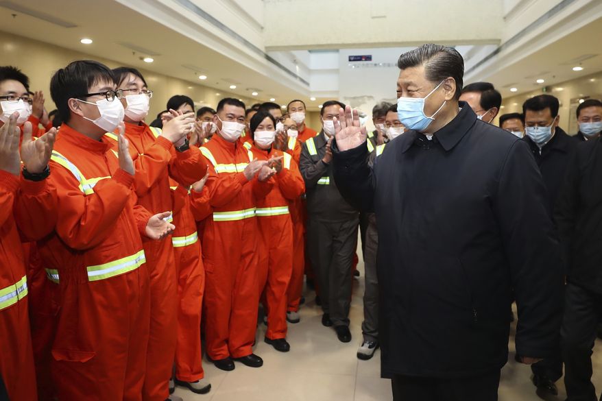 In this photo released by Xinhua News Agency, Chinese President Xi Jinping visits the Chuanshan port area of the Ningbo-Zhoushan Port in east China&#x27;s Zhejiang Province, Sunday, March 29, 2020. Authorities in China are working to restart its industries as number of new coronavirus cases and deaths fall in the country. (Ju Peng/Xinhua via AP)