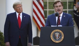 My Pillow CEO Mike Lindell speaks as President Donald Trump listens during a briefing about the coronavirus in the Rose Garden of the White House, Monday, March 30, 2020, in Washington. (AP Photo/Alex Brandon)