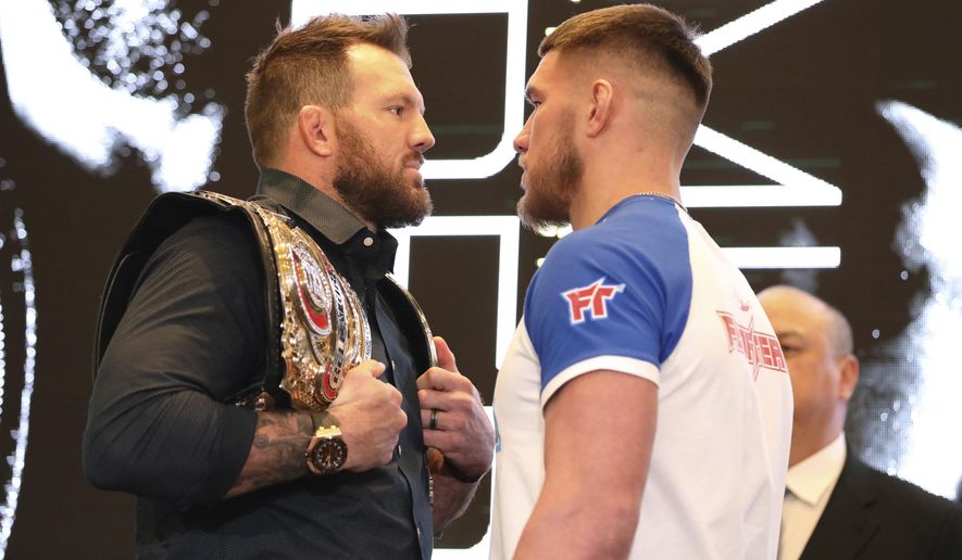 In this March 9, 2020, photo, Ryan Bader, left, squares off with Vadim Nemkov at a news conference promoting the Bellator Spring & Summer fight cards in New York City. Bellator is still hopeful of running its next mixed martial arts card on May 9. That event could be in jeopardy after President Donald Trump extended federal guidelines recommending people stay home for another 30 days until the end of April to prevent the spread of the new coronavirus. (AP Photo/Gregory Payan)
