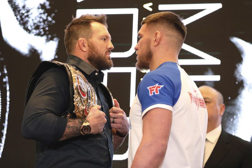 In this March 9, 2020, photo, Ryan Bader, left, squares off with Vadim Nemkov at a news conference promoting the Bellator Spring & Summer fight cards in New York City. Bellator is still hopeful of running its next mixed martial arts card on May 9. That event could be in jeopardy after President Donald Trump extended federal guidelines recommending people stay home for another 30 days until the end of April to prevent the spread of the new coronavirus. (AP Photo/Gregory Payan)