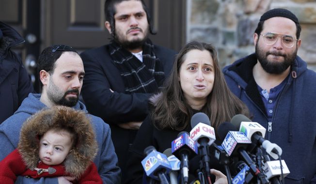FILE - In this Jan. 2, 2020, file photo, surrounded primarily by family, Nicky Kohen, the daughter of Josef Neumann who was critically injured in an attack on a Hanukkah celebration, speaks to reporters in front of her home in New City, N.Y. An Orthodox Jewish organization said Neumann died Sunday, March 29, 2020, from his injuries three months after the attacks. (AP Photo/Seth Wenig, File)