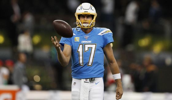 FILE - In this Nov. 18, 2019, file photo, Los Angeles Chargers quarterback Philip Rivers warms up before an NFL football game against the Kansas City Chiefs in Mexico City. Rivers is coming off one of the poorest seasons in his NFL career. The longtime quarterback for the San Diego and Los Angeles Chargers is now with the Colts after signing a one-year, $25 million contract. (AP Photo/Rebecca Blackwell, File)