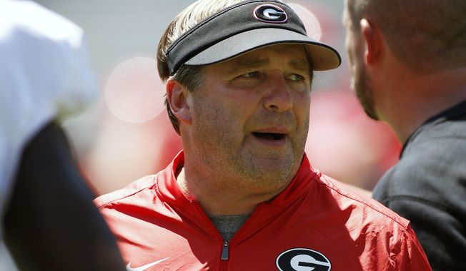 FILE - In this Aug. 17, 2019, file photo, Georgia coach Kirby Smart looks on during warm ups for an NCAA football preseason scrimmage in Athens, Ga. Georgia coach Kirby Smart says quarterback is the position most affected by spring practice being canceled by the coronavirus pandemic. It&#x27;s bad timing for the Bulldogs, who would have used the spring as a time to have Wake Forest transfer Jamie Newman and others compete to replace three-year starter Jake Fromm. (Joshua L. Jones/Athens Banner-Herald via AP, File)/Athens Banner-Herald via AP)