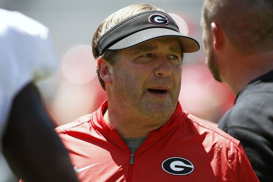 FILE - In this Aug. 17, 2019, file photo, Georgia coach Kirby Smart looks on during warm ups for an NCAA football preseason scrimmage in Athens, Ga. Georgia coach Kirby Smart says quarterback is the position most affected by spring practice being canceled by the coronavirus pandemic. It&#39;s bad timing for the Bulldogs, who would have used the spring as a time to have Wake Forest transfer Jamie Newman and others compete to replace three-year starter Jake Fromm. (Joshua L. Jones/Athens Banner-Herald via AP, File)/Athens Banner-Herald via AP)