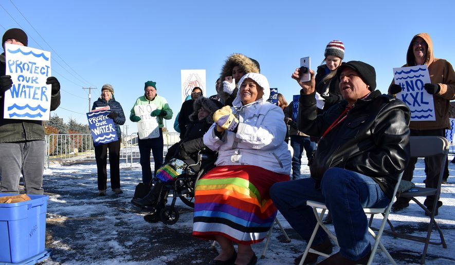FILE - In this Oct. 29, 2019 file photo, opponents of the Keystone XL oil pipeline from Canada demonstrate in sub-freezing temperatures in Billings, Mont. Alberta is investing $1.1 billion in the disputed Keystone XL pipeline, a project that Alberta Premier Jason Kenney says is crucial for the province&#39;s economy. (AP Photo/Matthew Brown, File)