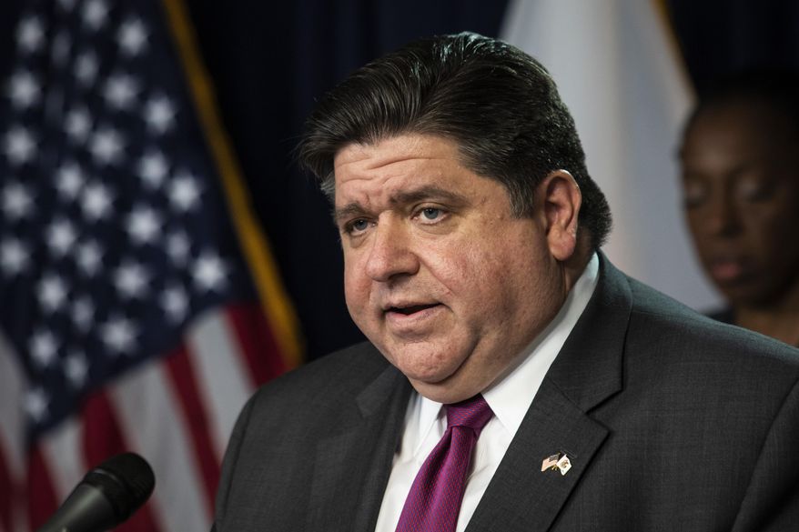 FILE - In this March 30, 2020 file photo, Illinois Gov. J.B. Pritzker speaks at the Thompson Center in Chicago during the daily update on the state's response to the coronavirus pandemic. Pritzker on March 31, 2020, extended his statewide stay-at-home order for three weeks as the nation struggles to contain the spread of the coronavirus. Pritzker set a new deadline of April 30 for keeping people inside except for essential needs and jobs. (Ashlee Rezin Garcia/Chicago Sun-Times via AP File)