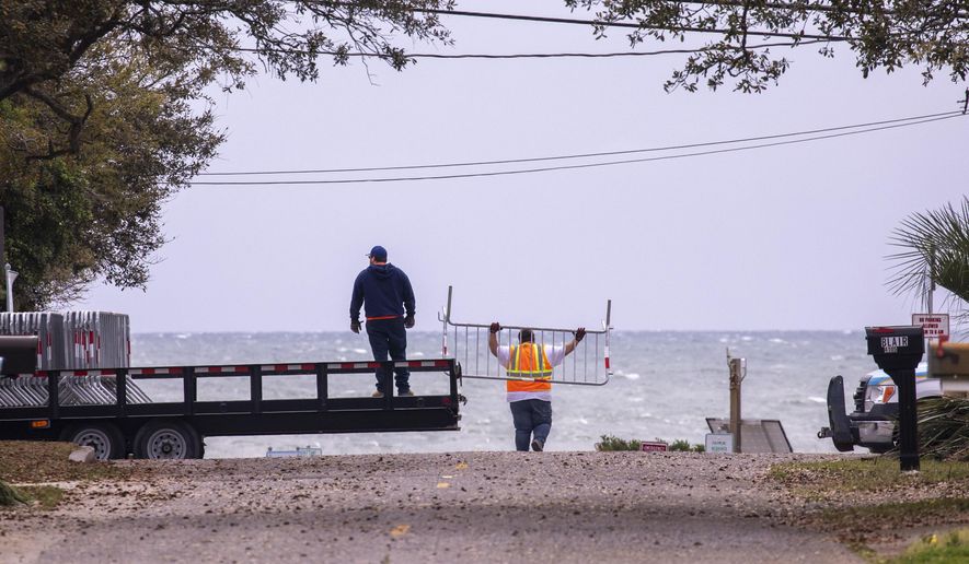 Myrtle Beach Public Works crews close down public beach access points on Tuesday morning, March 31, 2020. following S.C. Governor Henry McMaster's order to close access to beaches and public waterways amid the coronavirus threat. (Jason Lee/The Sun News via AP)