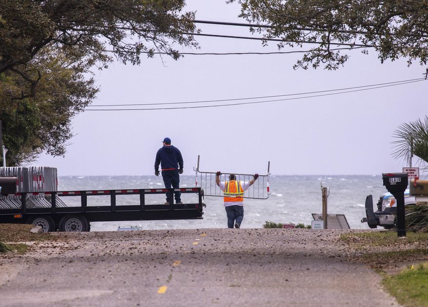 Myrtle Beach Public Works crews close down public beach access points on Tuesday morning, March 31, 2020. following S.C. Governor Henry McMaster's order to close access to beaches and public waterways amid the coronavirus threat. (Jason Lee/The Sun News via AP)