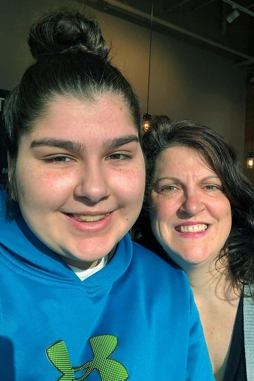 This January 2020 photo shows Anna Mandh, left, and her mother, Darlene Gildersleeve, in Concord, N.H. Gildersleeve is among many parents concerned about access to special education services as schools have shifted to remote learning due to the new coronavirus. (Darlene Gildersleeve via AP)