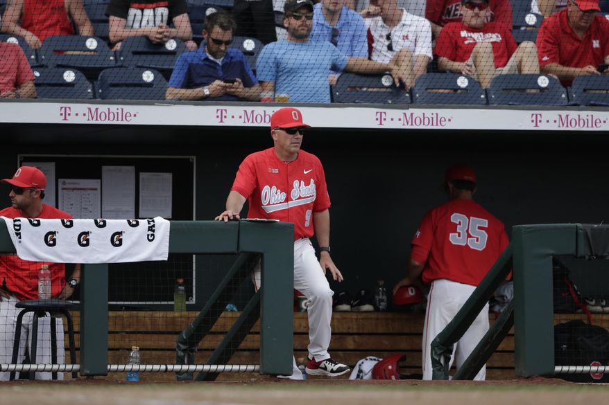 In this May 26, 2019, photo, Ohio State coach Greg Beals stands in the dugout at TD Ameritrade Park during the NCAA Big Ten baseball championship game in Omaha, Neb. Beals said Tuesday, March 31, 2020, that he isn't worried about the 2021 season, when the NCAA will relax the roster limit to accommodate seniors who return for another season. But with 11 incoming freshmen joining nine players who will be getting a second freshman year in 2021, Beals will face a logjam of players in 2022, especially with the 35-man roster limit back in force.(AP Photo/Nati Harnik)