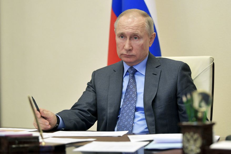 Russian President Vladimir Putin chairs a cabinet meeting via videoconference at the Novo-Ogaryovo residence outside Moscow, Russia, Wednesday, April 1, 2020. The new coronavirus causes mild or moderate symptoms for most people, but for some, especially older adults and people with existing health problems, it can cause more severe illness or death. (Alexei Druzhinin, Sputnik, Kremlin Pool Photo via AP)