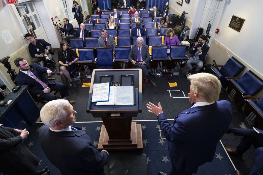 Vice President Mike Pence, left, and President Donald Trump speak about the coronavirus in the James Brady Press Briefing Room of the White House, Wednesday, April 1, 2020, in Washington. (AP Photo/Alex Brandon)