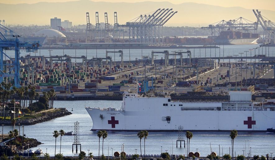 FILE - In this March 27, 2020, file photo, The USNS Mercy enters the Port of Los Angeles in Los Angeles. A train engineer intentionally drove a speeding locomotive off a track at the Port of Los Angeles because he was suspicious about the presence of a Navy hospital ship docked there amid the coronovirus crisis. The locomotive crashed through a series of barriers before coming to rest more than 250 yards from the U.S. Navy Hospital Ship Mercy on Tuesday, March 31, 2020. Nobody was hurt. (AP Photo/Mark J. Terrill, File)