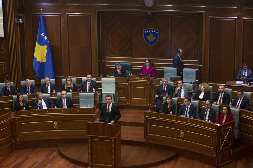 Albin Kurti, foreground, the newly elected prime minister of Kosovo delivers a speech, in the capital Pristina, Monday, Feb. 3, 2020.  Kosovo&#39;s parliament convened on Monday to vote in a new prime minister after four months of talks between the country&#39;s two main parties. (AP Photo/Visar Kryeziu)