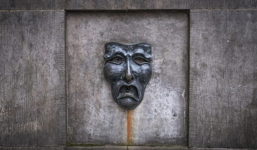 A bronze theatre mask on Edinburgh&#x27;s Royal Mile, in Edinburgh, Scotland,  Wednesday April 1, 2020. Every August, the Scottish capital of Edinburgh plays host to some of the funniest and talented — not to forget the strangest — artists from the U.K. and the wider world. Not this year, as organizers made the decision Wednesday to cancel the city&#x27;s festivals as a result of the coronavirus pandemic. (Jane Barlow/PA via AP)