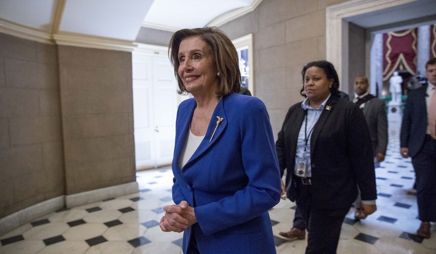 In this March 27, 2020, photo, House Speaker Nancy Pelosi of Calif., walks to her office after signing the Coronavirus Aid, Relief, and Economic Security (CARES) Act on Capitol Hill in Washington. (AP Photo/Andrew Harnik) **FILE**