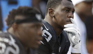 FILE - In this Sept. 13, 2015, file photo, Oakland Raiders linebacker Aldon Smith (99) sits on the bench during the second half of the team&#39;s NFL football game against the Cincinnati Bengals in Oakland, Calif. The Dallas Cowboys are taking a chance on another suspended defensive end, signing Aldon Smith to a contract while his playing status in the NFL is up in the air. A person with direct knowledge of the deal said Smith signed Wednesday, April 1, 2020. The person spoke to The Associated Press on condition of anonymity because the signing hadn&#39;t been announced.  (AP Photo/Ben Margot, File)