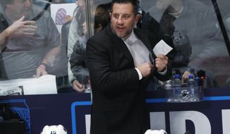 San Jose Sharks interim coach Bob Boughner directs his team against the Colorado Avalanche during the first period of an NHL hockey game Thursday, Jan. 16, 2020, in Denver. (AP Photo/David Zalubowski)