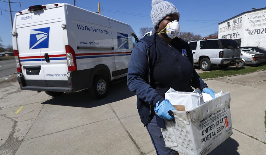 A United States Postal worker makes a delivery with gloves and a mask in Warren, Mich., Thursday, April 2, 2020. The U.S. Postal Service is keeping post offices open but ensuring customers stay at least 6 feet (2 meters) apart. The agency said it is following guidance from public health experts, although there is no indication that the new coronavirus COVID-19 is being spread through the mail. (AP Photo/Paul Sancya)