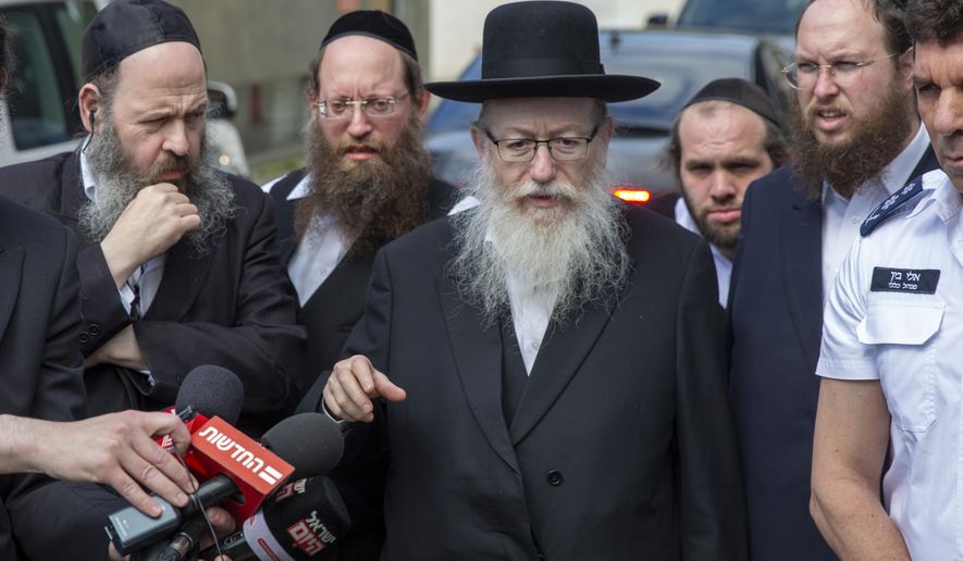 In this Monday, March 2, 2020 photo, Israel&#x27;s Health Minister Yaakov Litzman delivers a statement as he visits a makeshift tent for quarantined coronavirus voters in Tel Aviv, Israel. Litzman, who has had frequent contact with Prime Minister Benjamin Netanyahu and other top officials, has the new coronavirus, the Health Ministry announced Thursday. (AP Photo/Ariel Schalit)