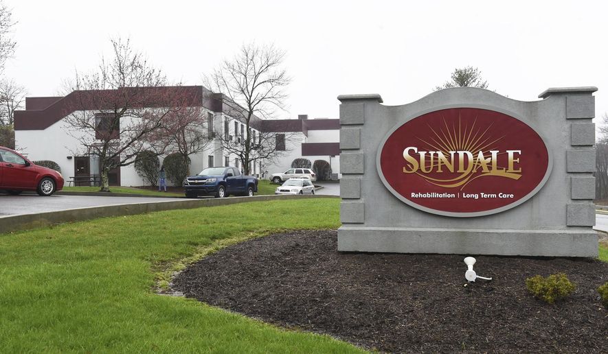 FILE - In this March 25, 2020, file photo, a Sundale nursing home sign sits on the property in Morgantown, W.Va., where several people have tested positive for the coronavirus. Nursing homes across the country went into lockdown this month with mandatory measures to protect their frail, elderly residents from coronavirus, but an alarming wave of deadly outbreaks nearly every day since suggests the steps that included a ban on visits and daily health screenings of staffers either came too late or were not rigorous enough. (Ron Rittenhouse/Dominion Post via AP, File)