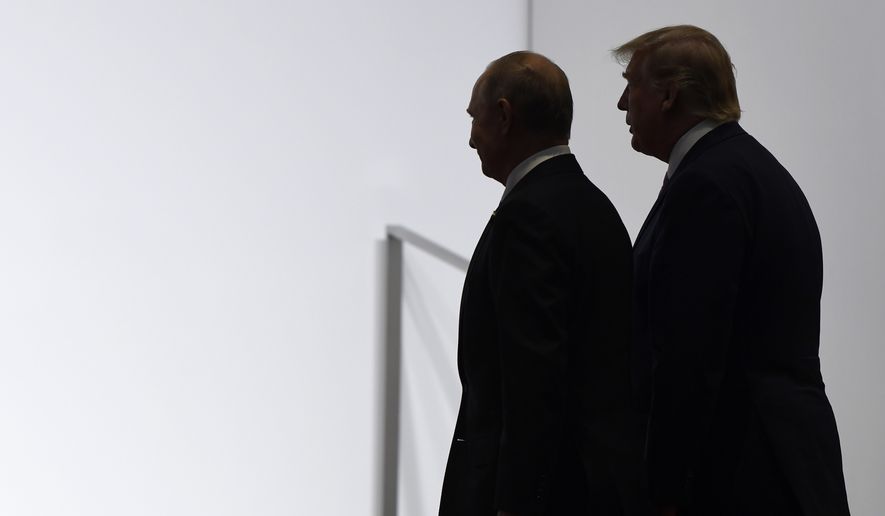 In this June 28, 2019, photo, President Donald Trump and Russian President Vladimir Putin walk to participate in a group photo at the G20 summit in Osaka, Japan. An odd new front in the U.S.-Russian rivalry has emerged as a Russian military cargo plane bearing a load of urgently needed medical supplies landed in New York&#39;s JFK airport. (AP Photo/Susan Walsh, File)