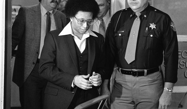 FILE - This Feb. 23, 1982 file photo shows Wayne B. Williams leaving the Fulton County Jail in Atlanta to go to court where he will continue testifying in his trial on charges of killing two black children in Atlanta. Williams was given two life sentences in connection to two of the 29 murders. A new HBO documentary “Atlanta’s Missing and Murder: The Lost Children” will take a deep dive into the case involving a string of murders that terrorized the city’s black community 40 years ago. With Atlanta’s mayor pushing to reopen in the case, the five-part series that airs Sunday will explore if Williams or anyone else was truly behind the killing spree. (AP Photo/Gary Gardiner, File)