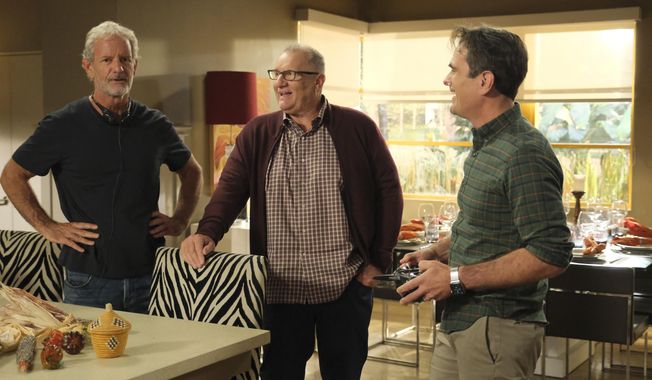 This image released by ABC shows, from left, executive producer Christopher Lloyd, and actors Ed O&#x27;Neill and Ty Burrell on the set of &amp;quot;Modern Family.&amp;quot; ABC’s “Modern Family” ends its 11-season run with a two-hour finale on Wednesday. (Tony Rivetti/ABC via AP)