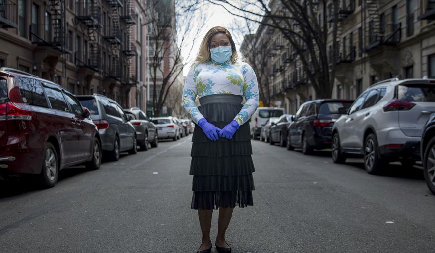 Tiffany Pinckney poses for a portrait in the Harlem neighborhood of New York on April 1, 2020. After a period of quarantine at home separated from her children, she has recovered from COVID-19. Pinckney became one of the nations first donors of "convalescent plasma." Doctors around the world are dusting off a century-old treatment for infections: Infusions of blood plasma teeming with immune molecules that helped survivors beat the new coronavirus. (AP Photo/Marshall Ritzell)