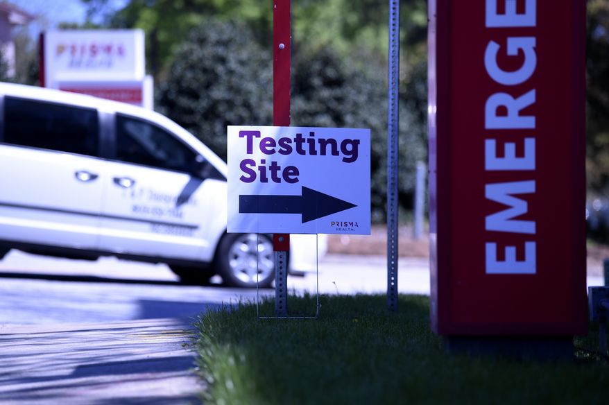 A car turns in at a location for drive-thru COVID-19 testing at Prisma Richland Hospital on Friday, April 3, 2020, in Columbia, S.C. (AP Photo/Meg Kinnard)