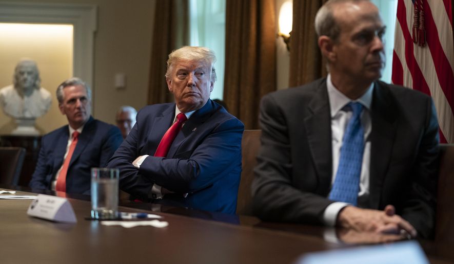 House Minority Leader Kevin McCarthy of Calif., President Donald Trump, and Chevron CEO Mike Wirth listen during a meeting with energy sector business leaders in the Cabinet Room of the White House, Friday, April 3, 2020, in Washington. (AP Photo/Evan Vucci)